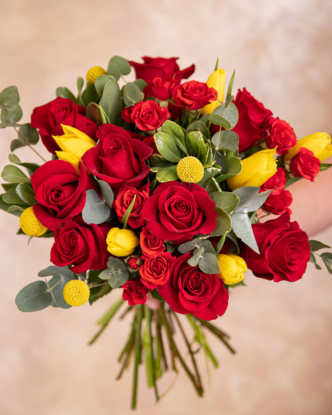 Bouquet with red roses, tulips and craspedia