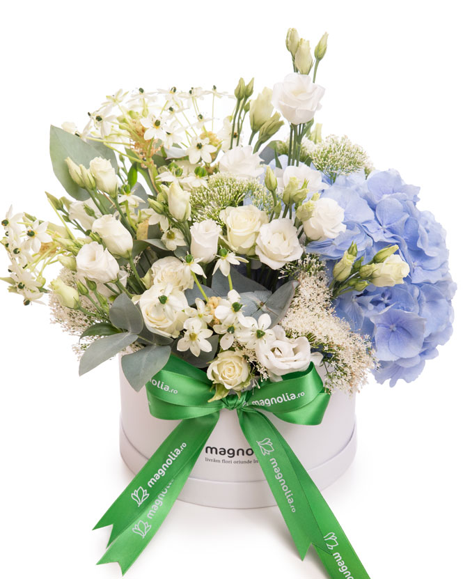 Floral arrangement with white roses and blue hydrangeas